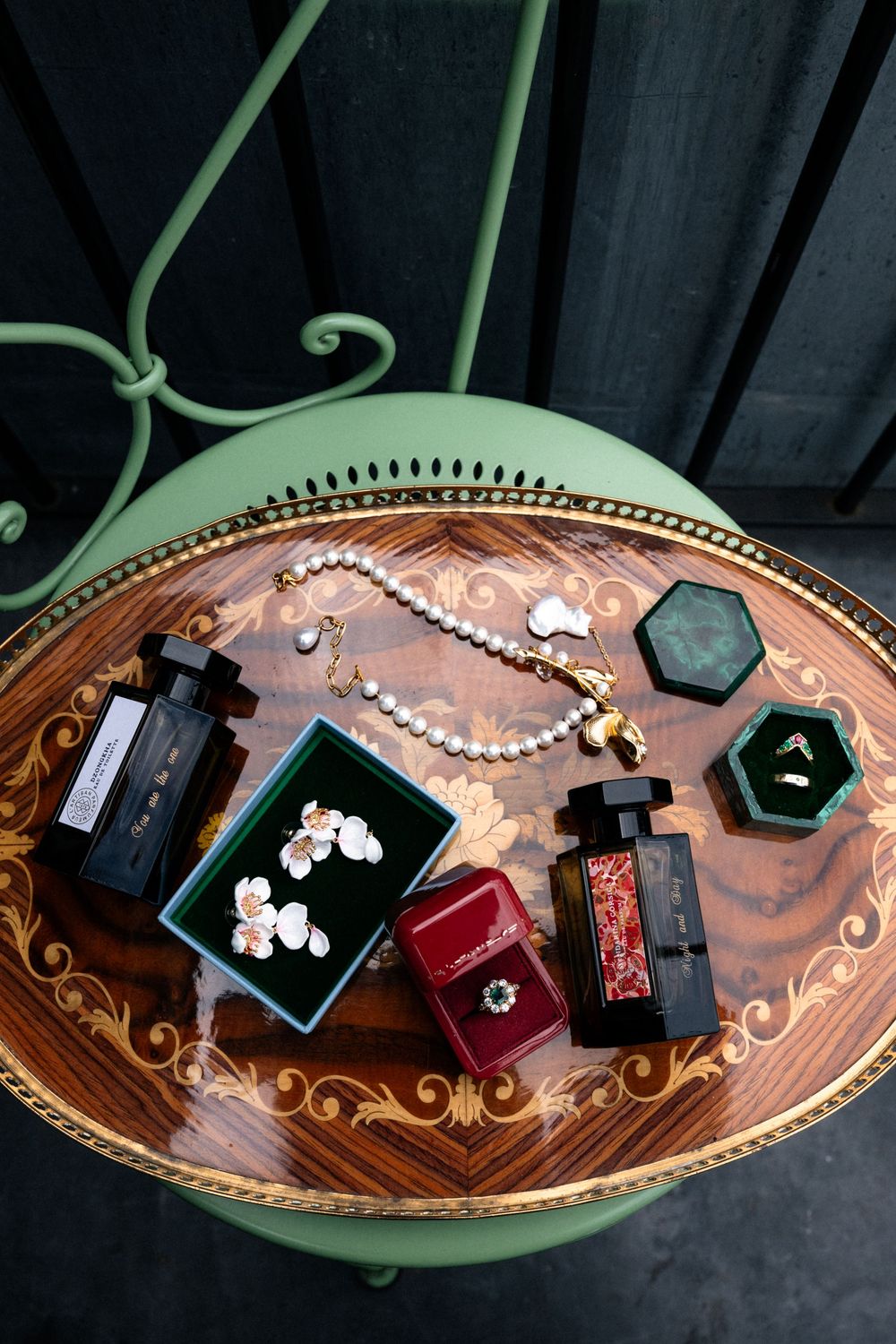 Wedding rings and jewelry displayed on an ornate copper-colored decorative tray with intricate patterns.