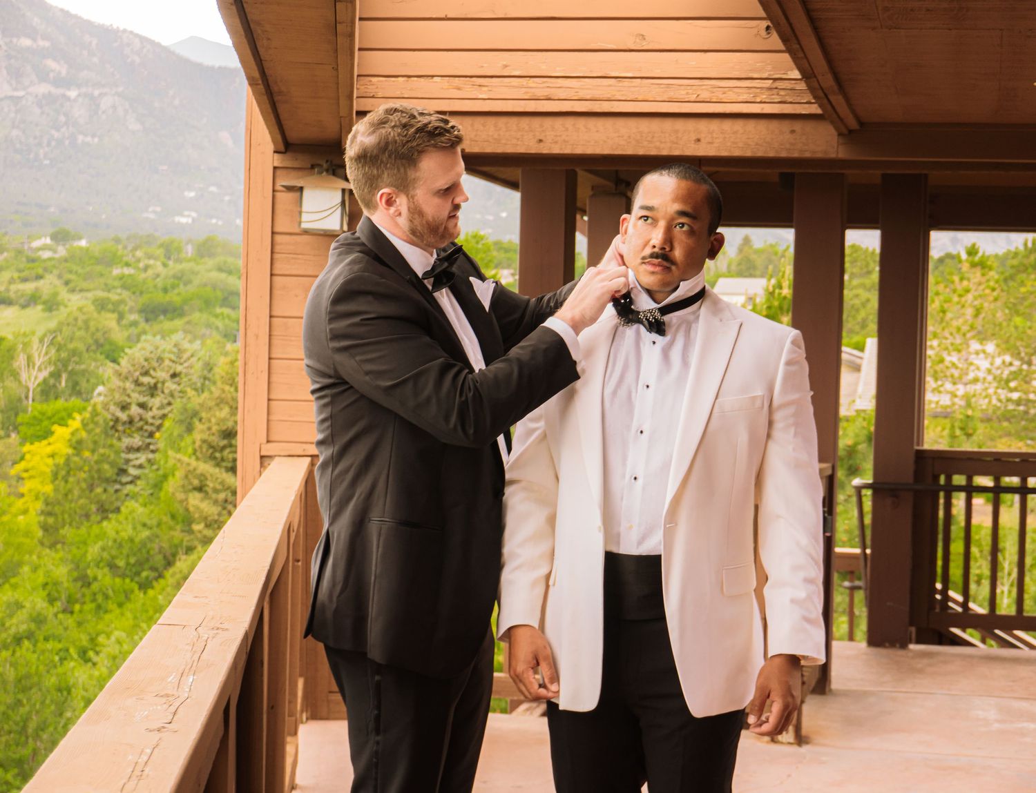 Colorado Springs Wedding Photographer. Photo of the groom and best man fixing their clothes for the big day.