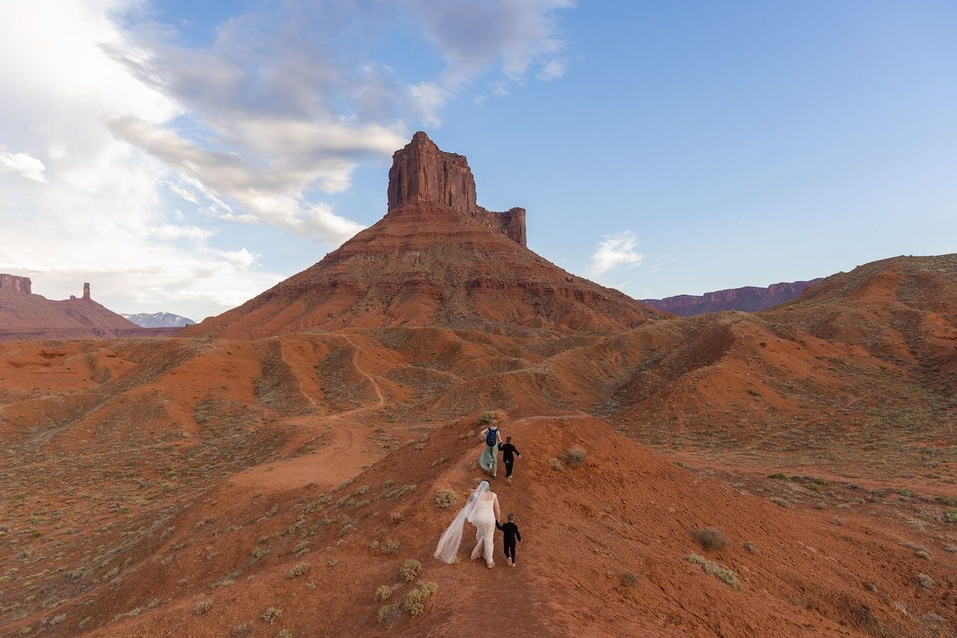 Planning your elopement in moab. couple in a desert landscape posing for photos at castle valley