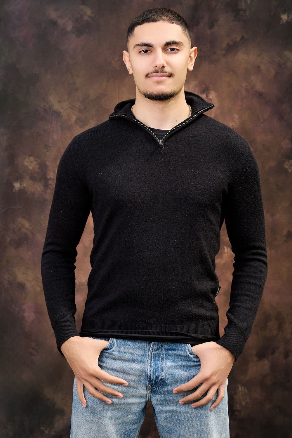 A split sequence showing a person in a black sweater and jeans posing against a dark backdrop in studio lighting.