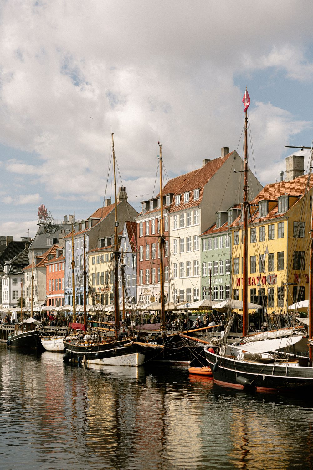 Historic Nyhavn canal in Copenhagen with vintage ships and colorful traditional buildings along the waterfront. Destination wedding