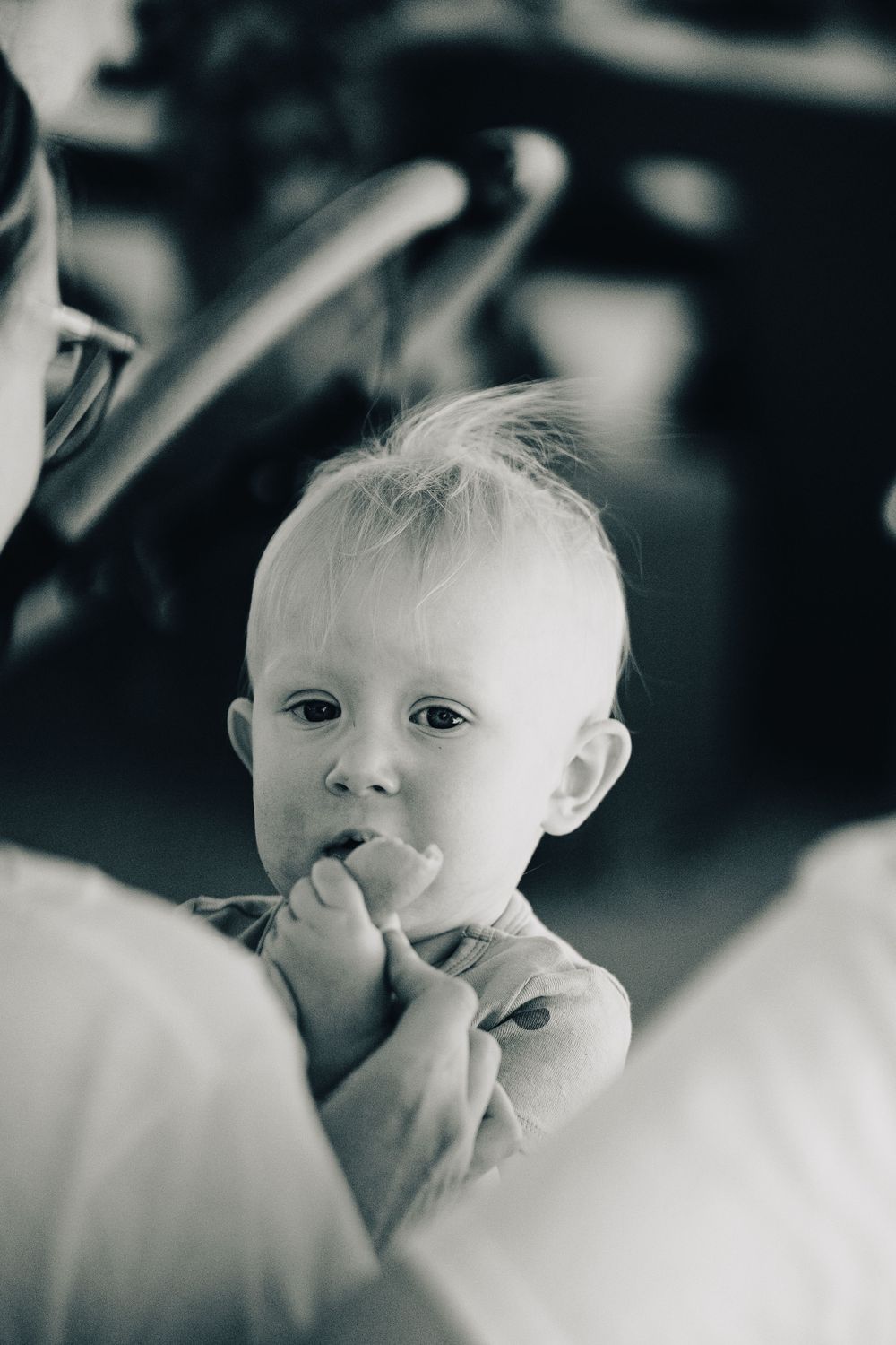 Black and white portrait of young child with curious expression.