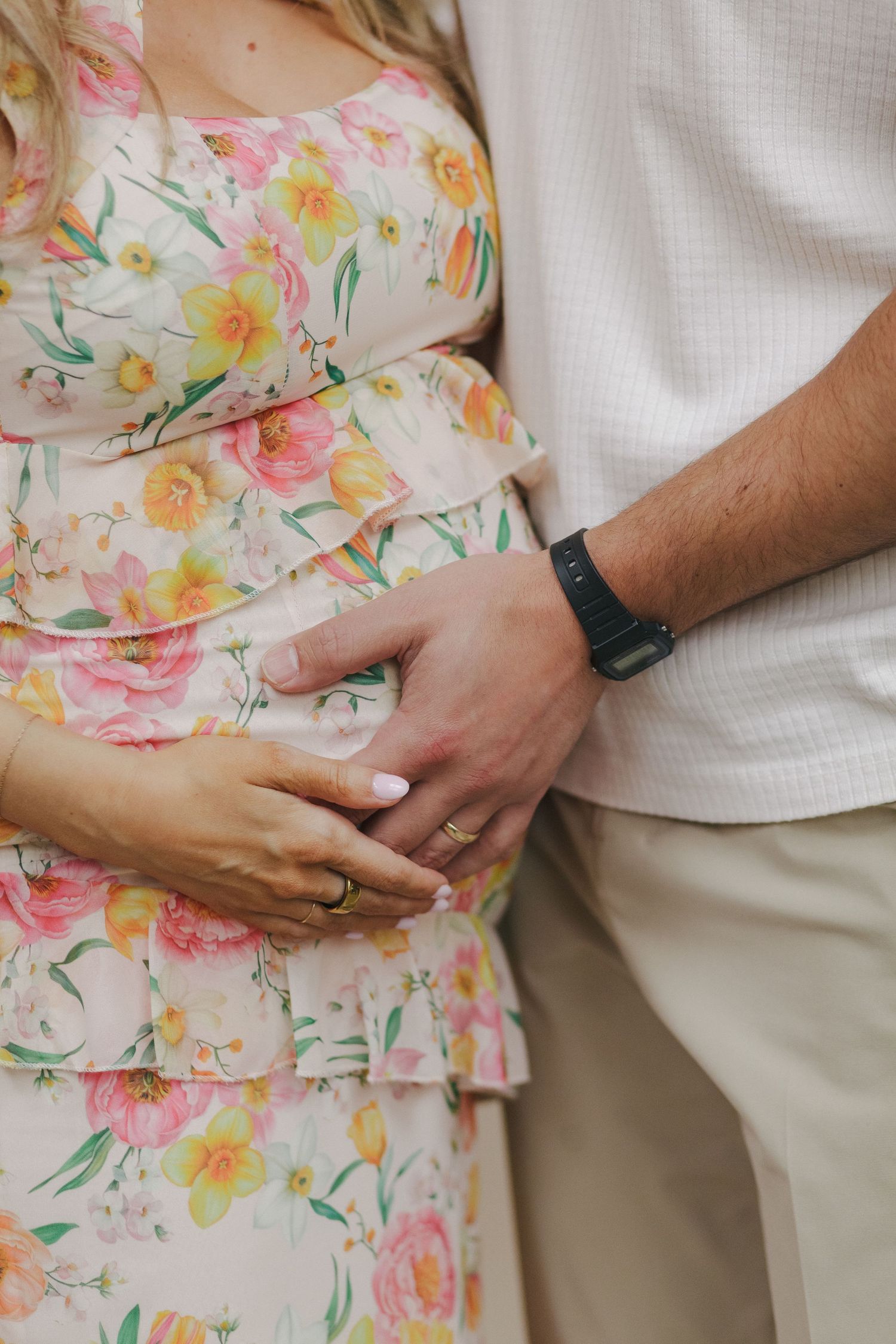 Heartwarming close-up of mom-and-dad-to-be’s hands gently cradling the baby bump, captured by NYC baby shower photographer Paula Brearley.