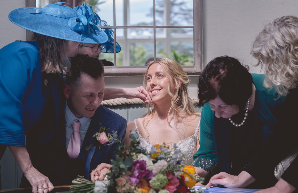 A mother strokes the cheek of her daughter fondly at the signing of the register