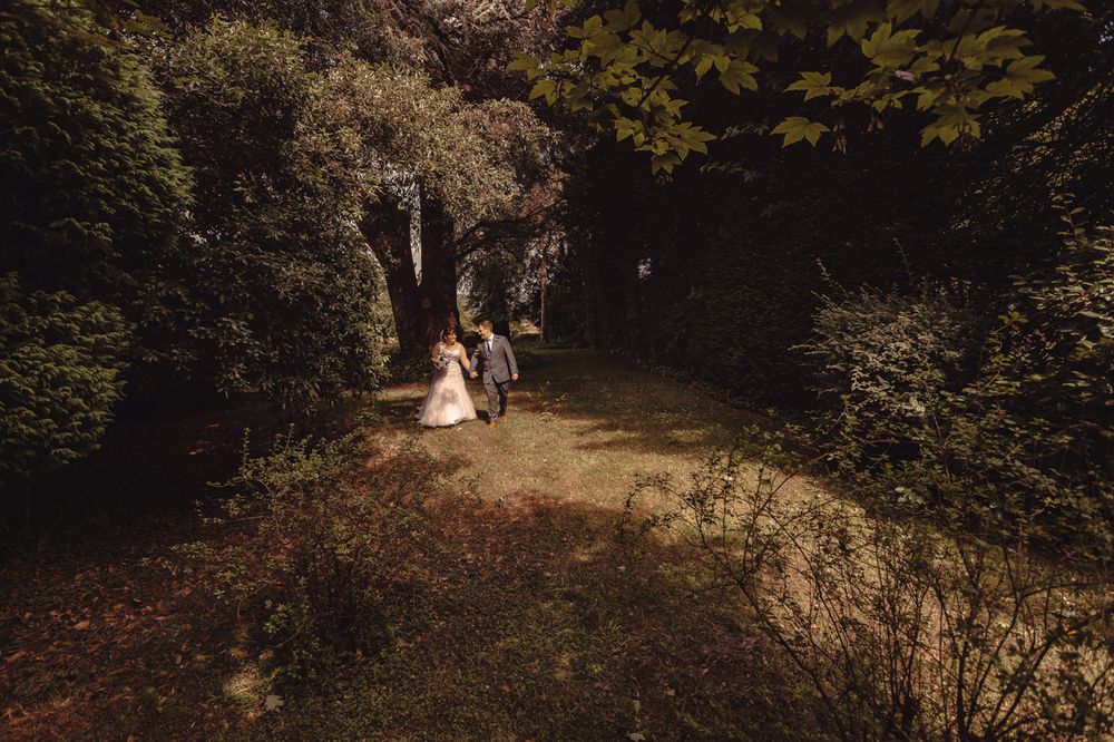 A wedding couple just married take a stroll on the grounds of The Lord Haldon Hotel