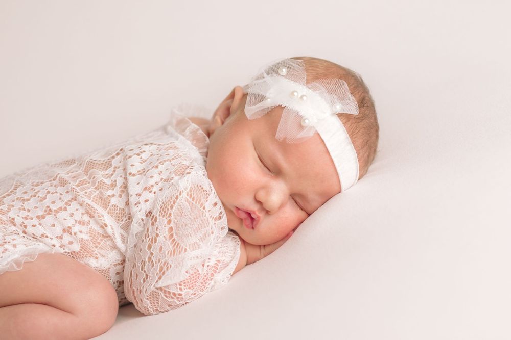 Buffalo In Home Newborn Session Photography. Newborn girl sleeping in lace outfit.