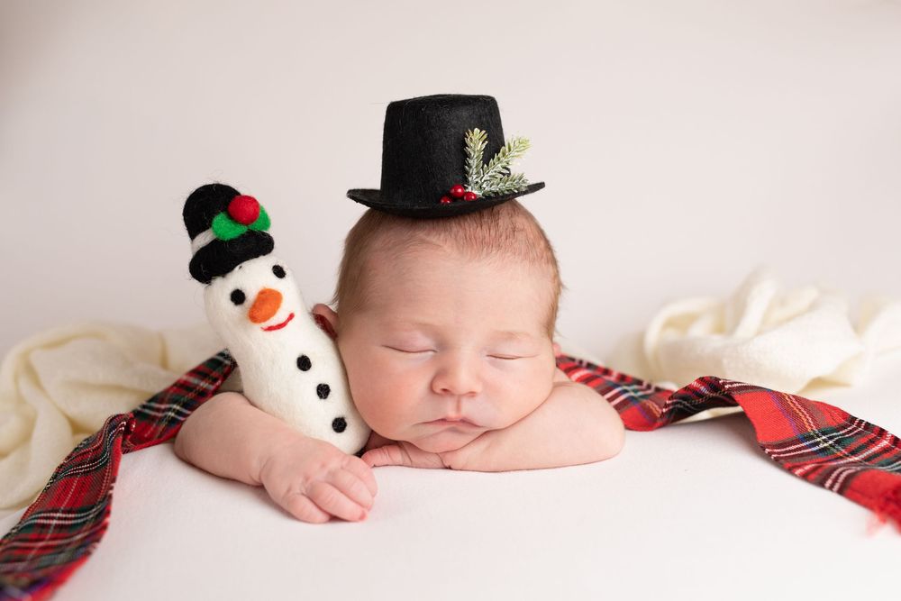 Buffalo In Home Newborn Session Photography. Newborn girl in Snowman costume. Christmas Newborn Session.