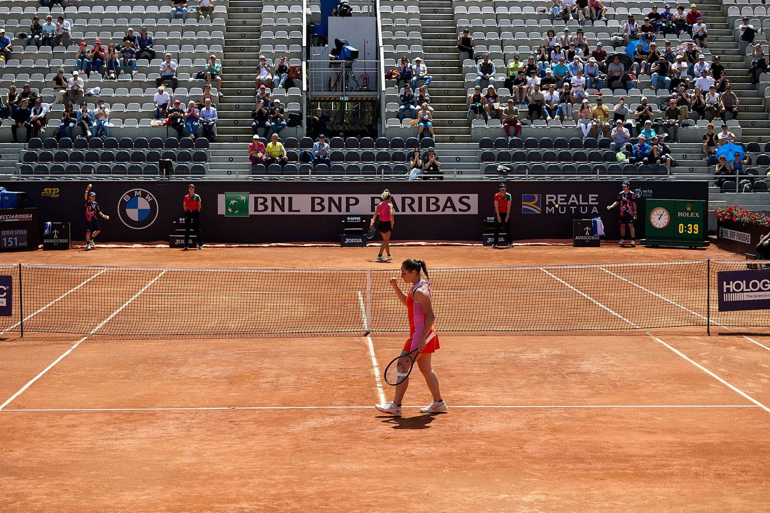 Wide view of clay tennis court during professional match with BNL BNP Paribas branding visible.