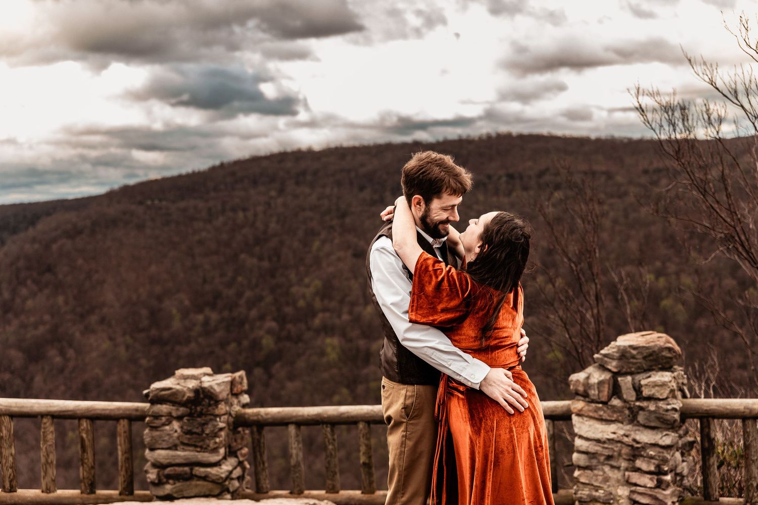 WV engaged couple embrace at Coopers Rock State Park