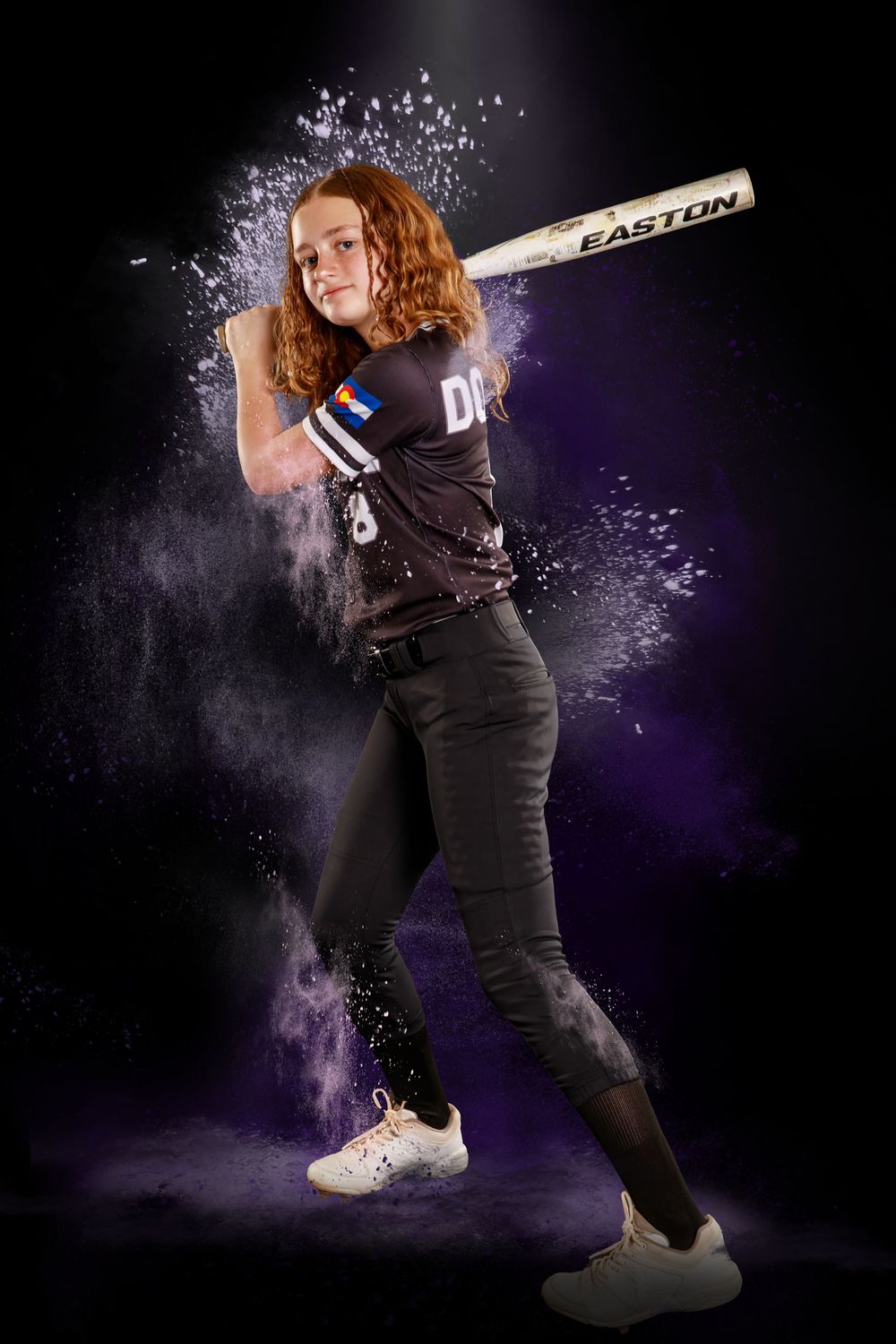 Action shots of softball player swinging bat against dark background with dramatic powder effects.