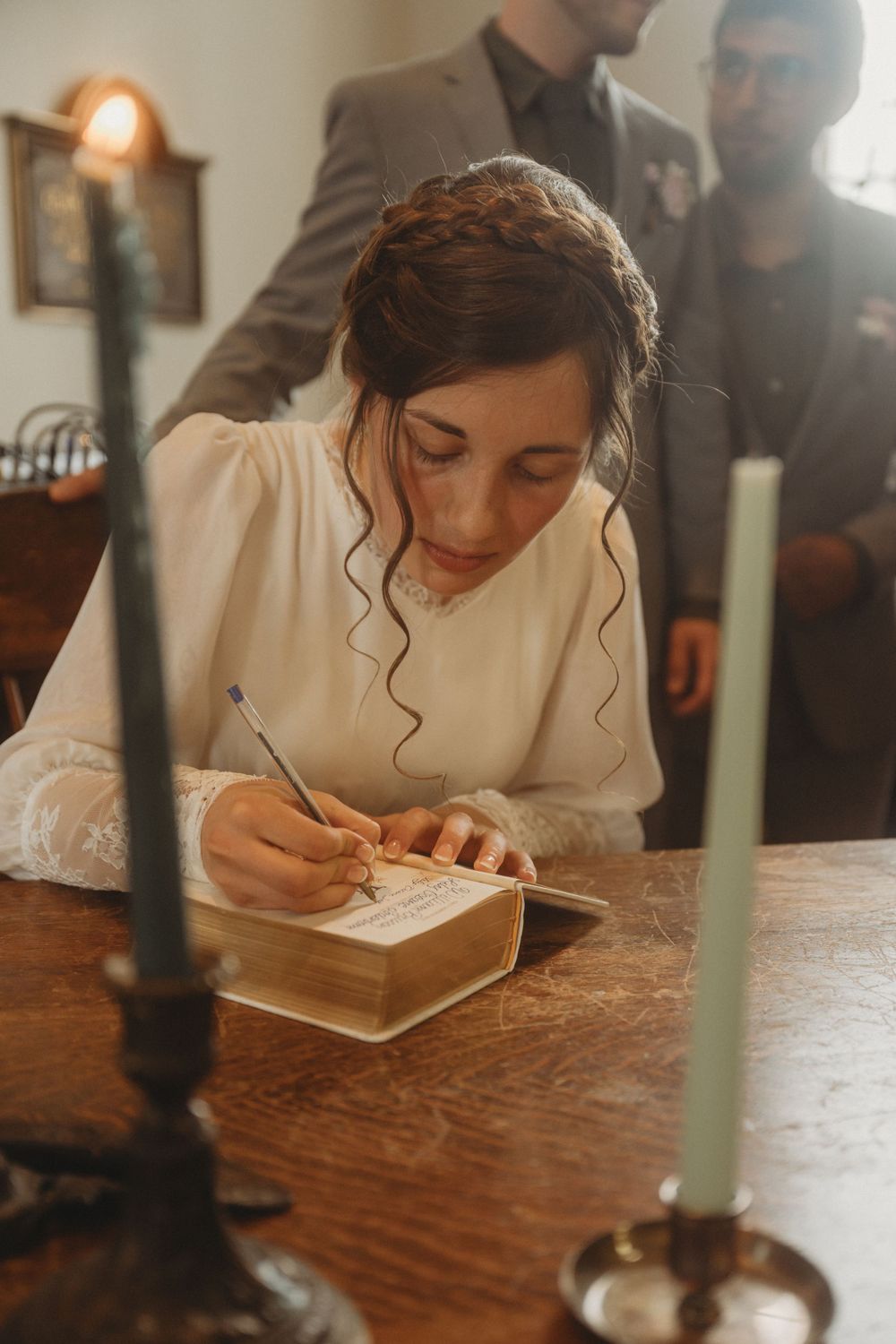 A wedding ceremony signing moment with candles and vintage decor.