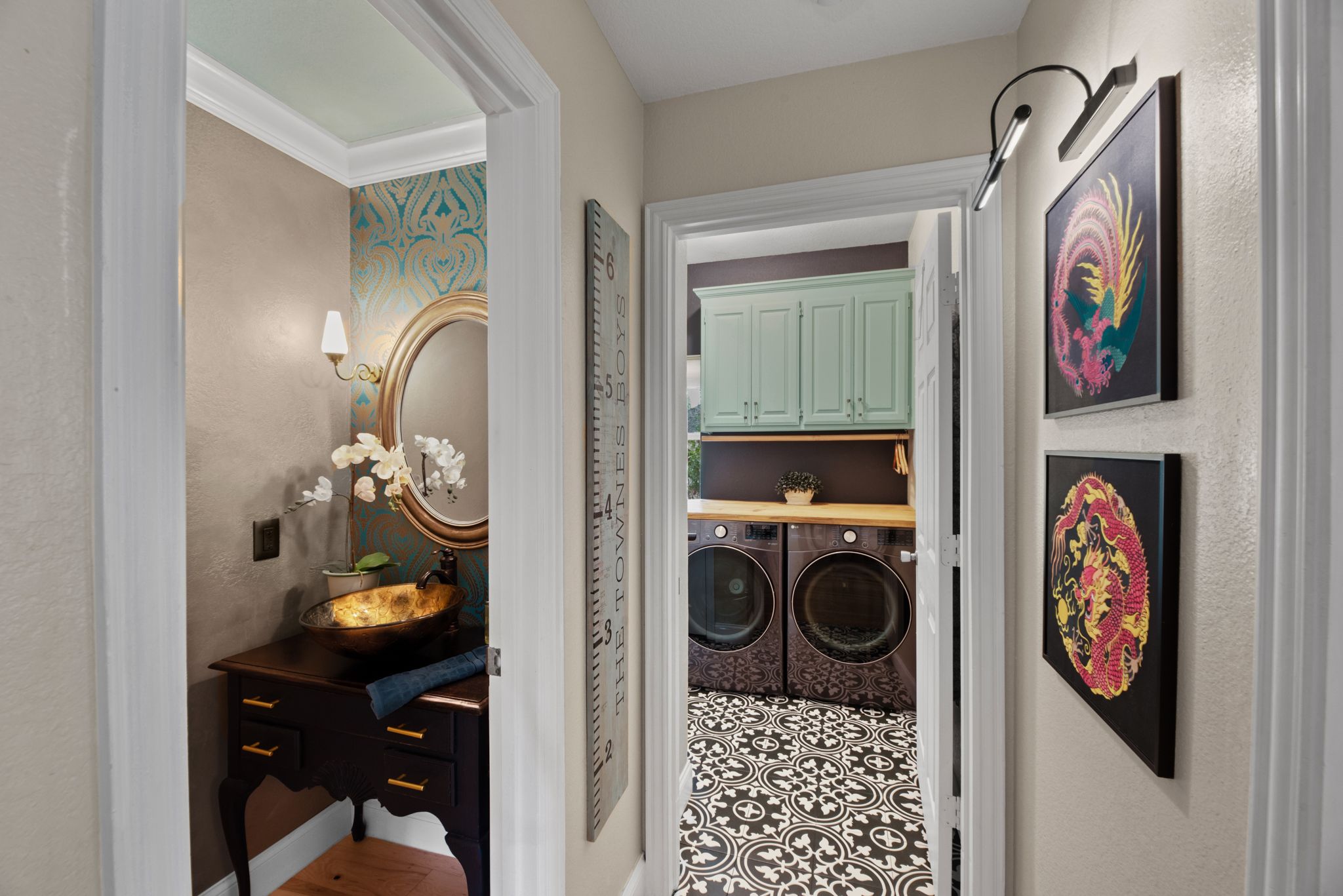 Hallway interior with art gallery wall display and hardwood flooring.