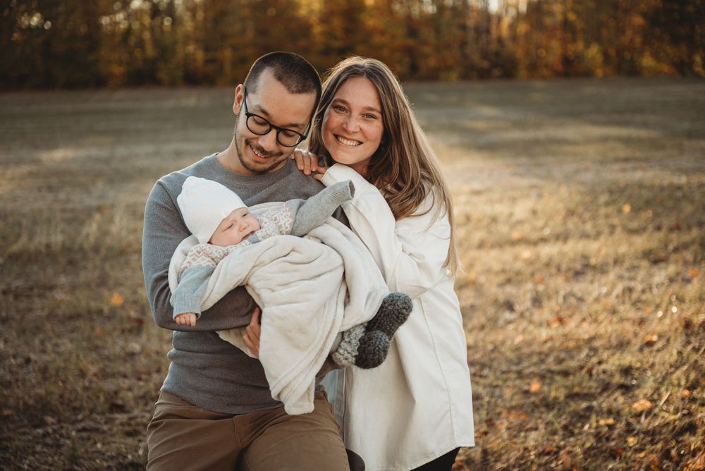 A loving family portrait set against warm autumn colors and late afternoon sunlight.