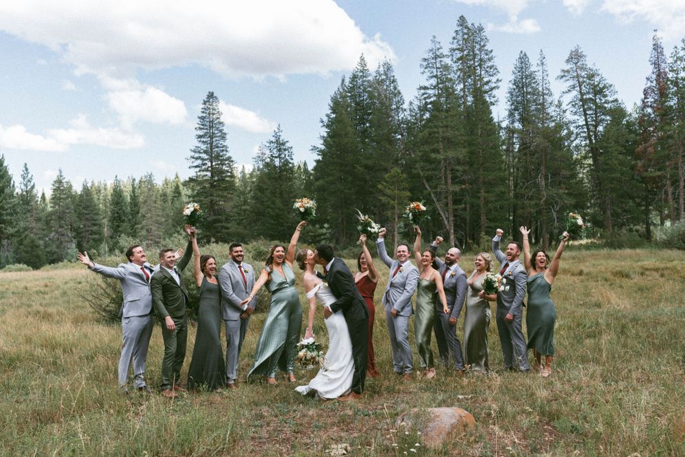 Wedding party celebrating in a mountain meadow surrounded by pine trees at truckee, ca