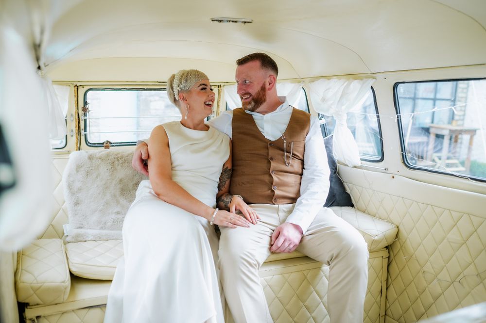 Happy couple in a vintage Volkswagen parked in The Village Barn, Tyrrellspass, Ireland.