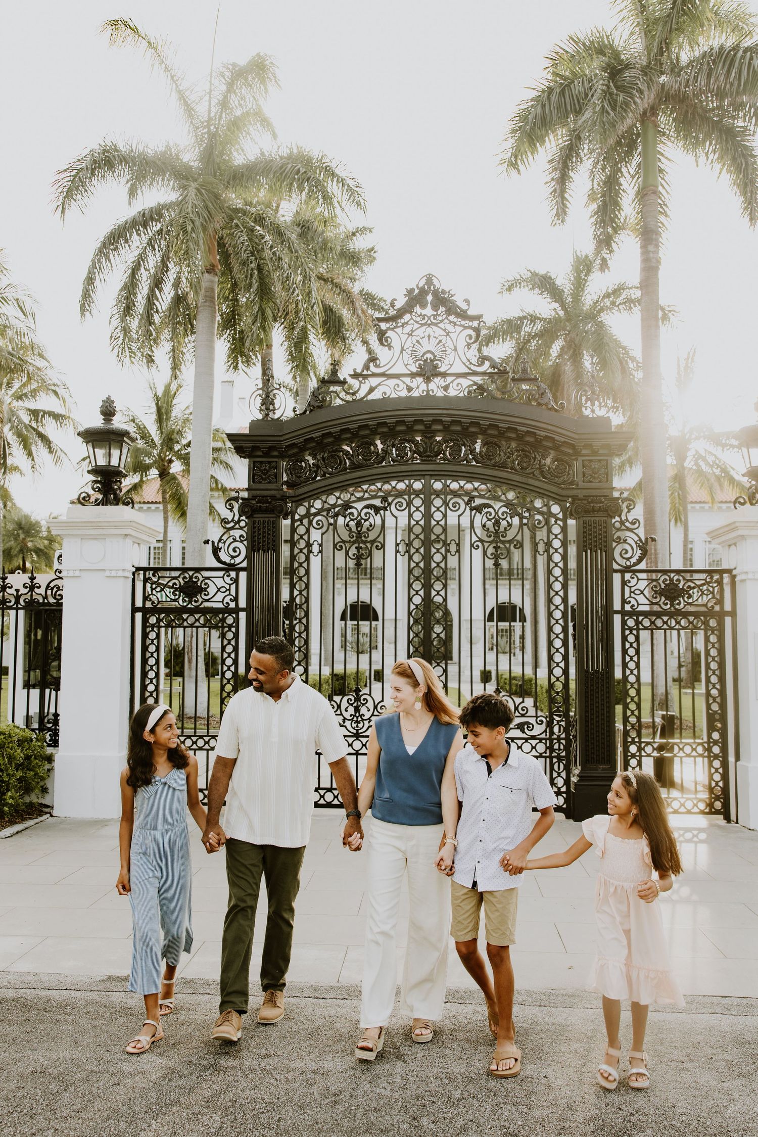 Golden hour summer family photos captured by Lindsay McDow Photography in front of Flagler Museum on Palm Beach Island