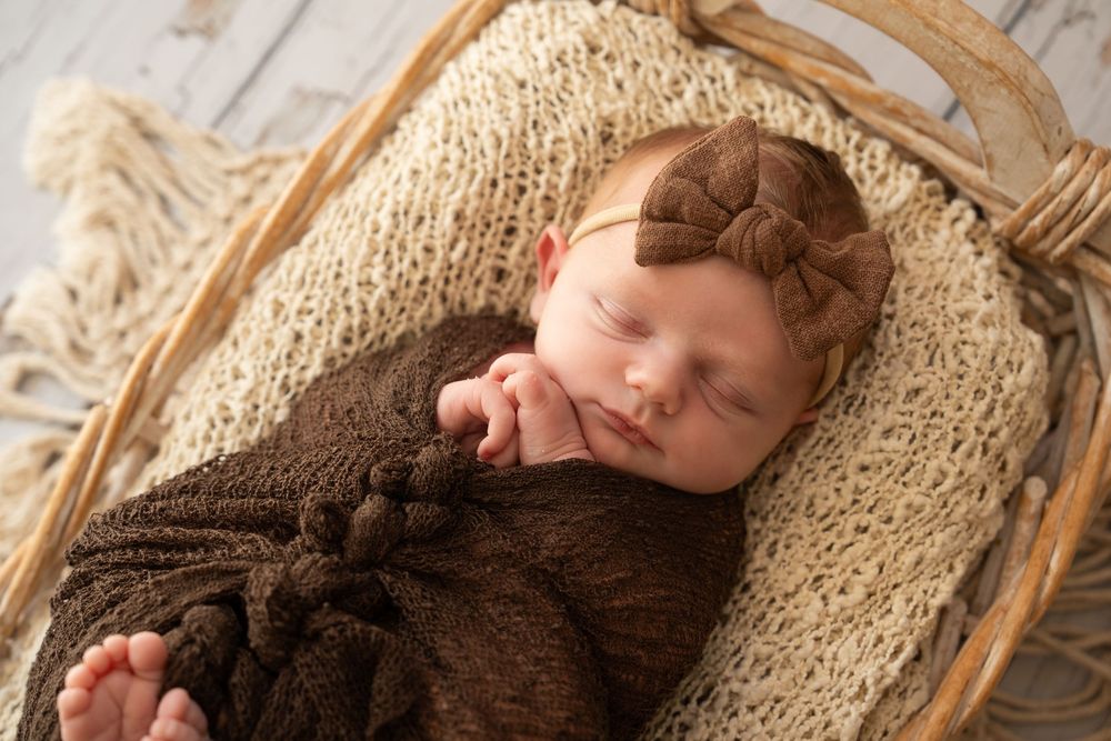 Cute baby sleeping in a basket