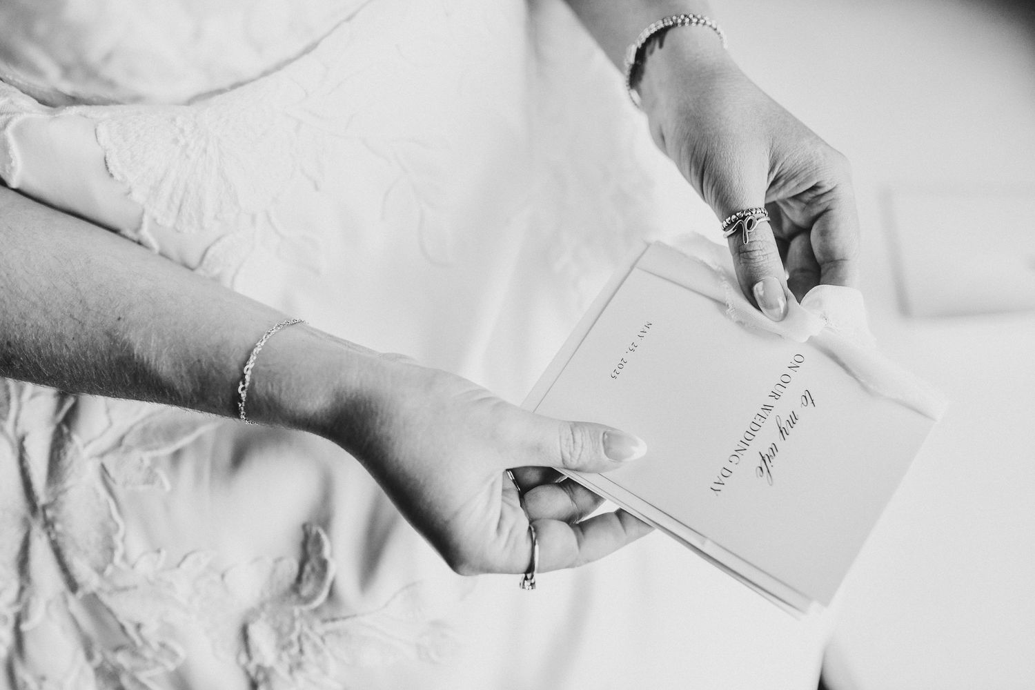the bride opens a love letter from her groom on their wedding day
