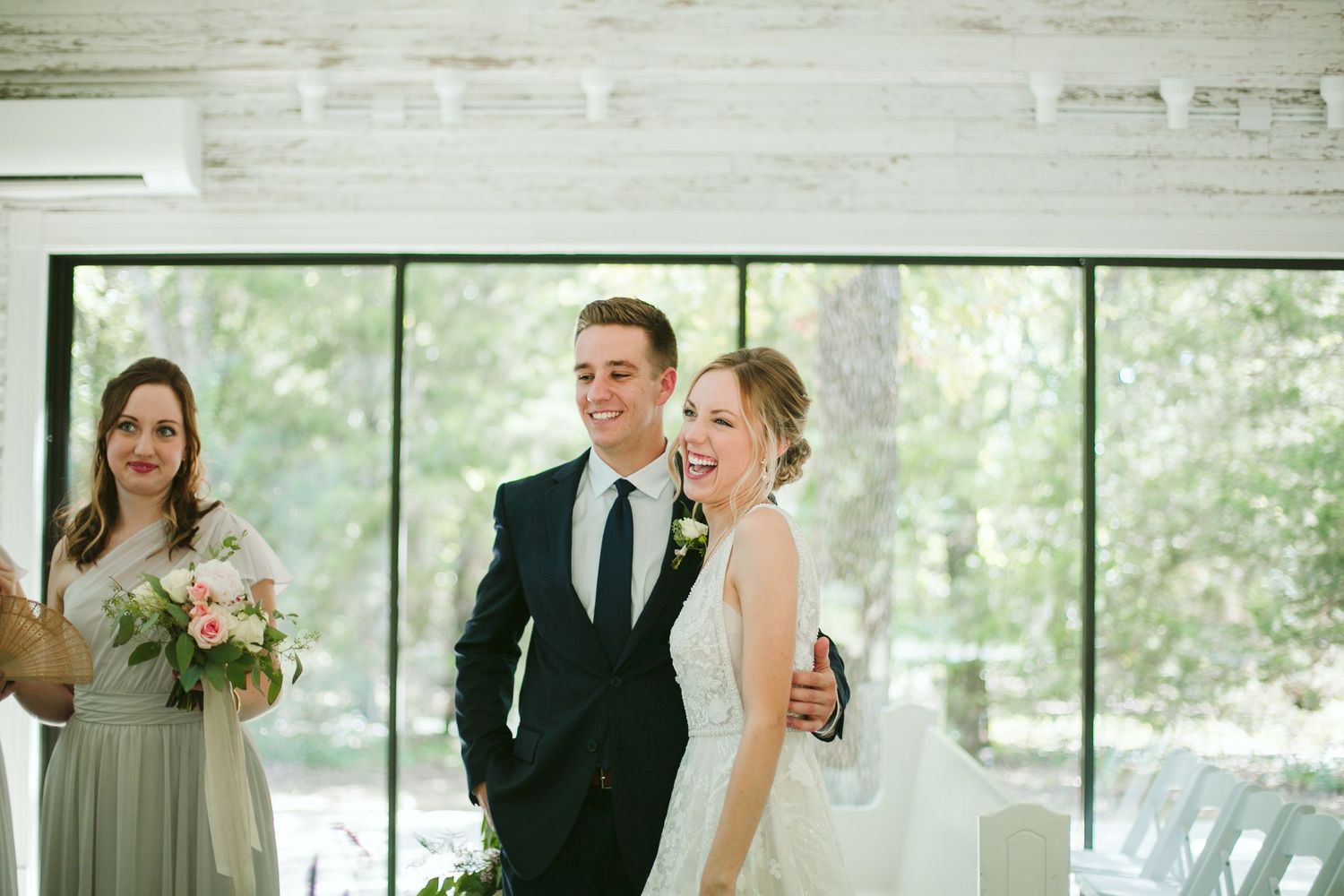 Joyful moment captured during wedding reception as couple shares a laugh.