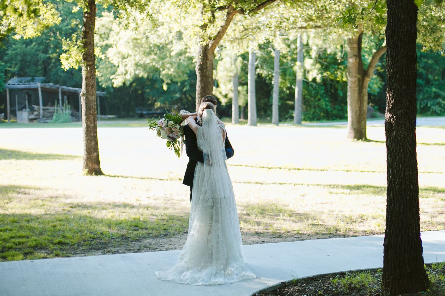 Wedding party members share joyful reactions during an outdoor ceremony.