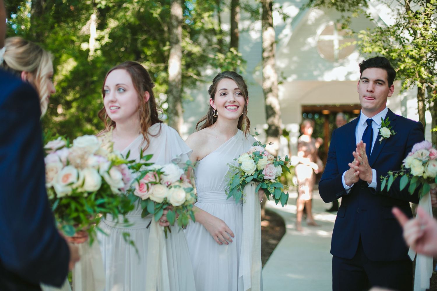Emotional embrace during wedding reception in an outdoor garden setting.