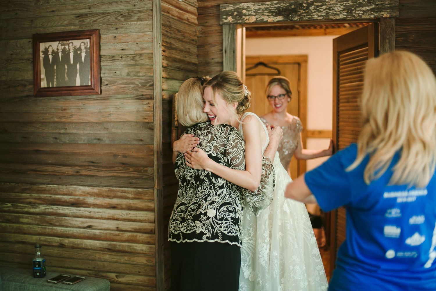 Emotional pre-wedding moment captured in rustic cabin setting.