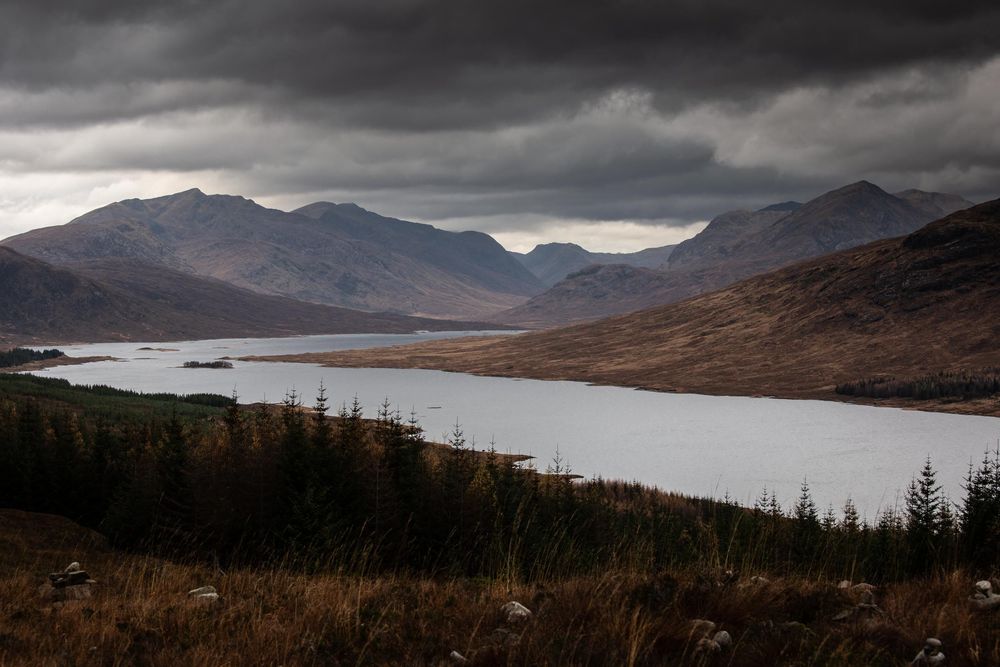 Set of dark moody landscape panoramas showing mountains and lakes under dramatic stormy skies in remote wilderness.