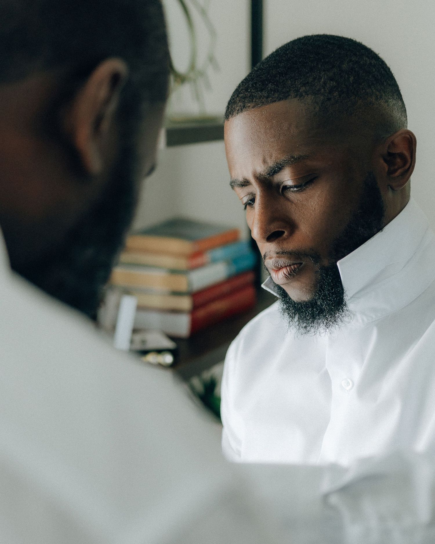 Two people in white shirts having a serious discussion.