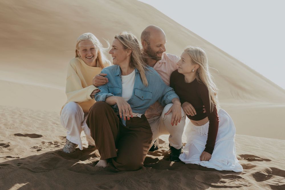 Joyful Belgian family exploring Sandwich Harbour during their guided tour and photoshoot experience in Namibia.