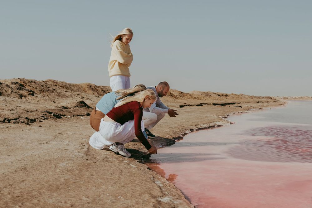 Joyful Belgian family exploring Sandwich Harbour during their guided tour and photoshoot experience in Namibia.
