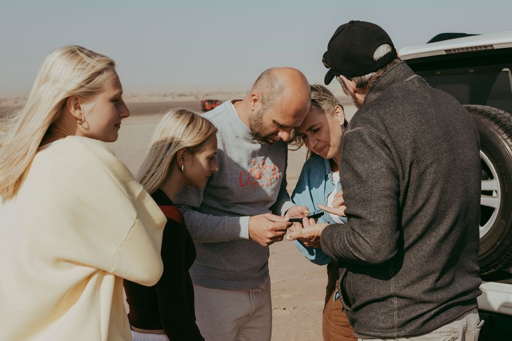 Joyful Belgian family exploring Sandwich Harbour during their guided tour and photoshoot experience in Namibia.