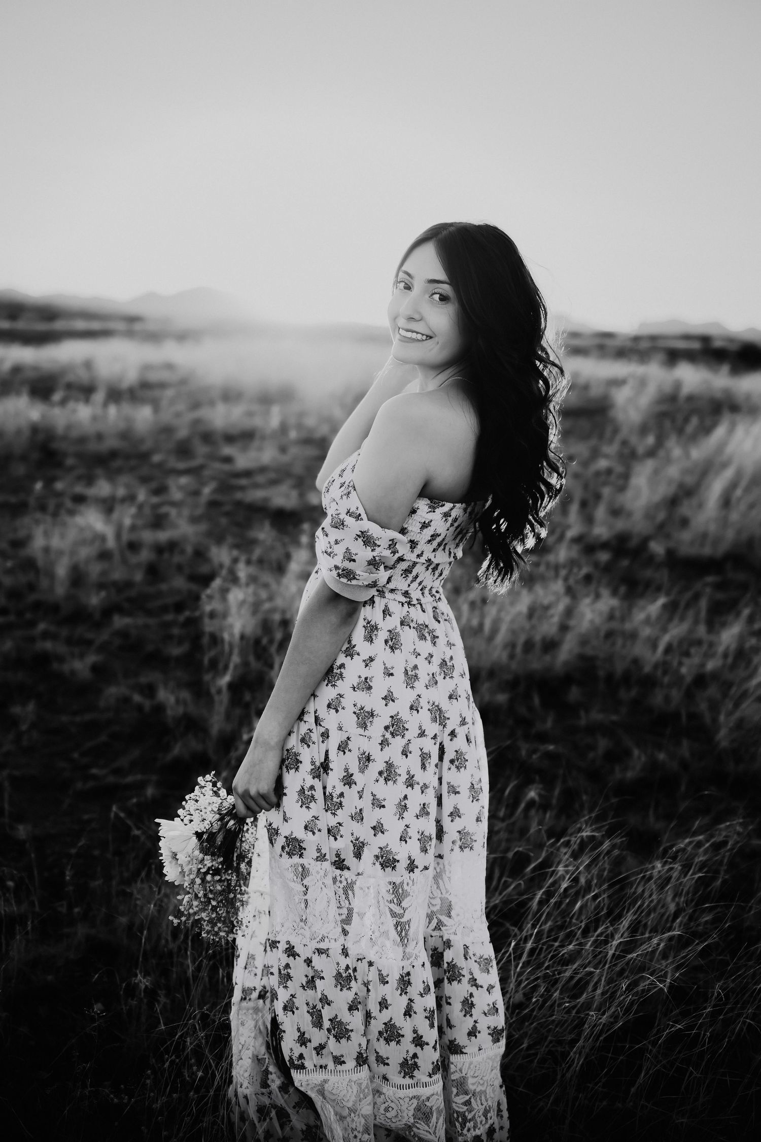 Black and White photo of senior girl in desert landscape in Sonoita AZ
