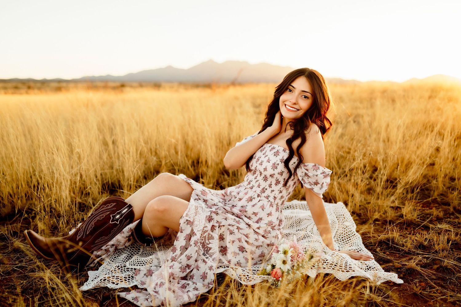 Senior girl sitting in golden grasslands near Tucson Arizona