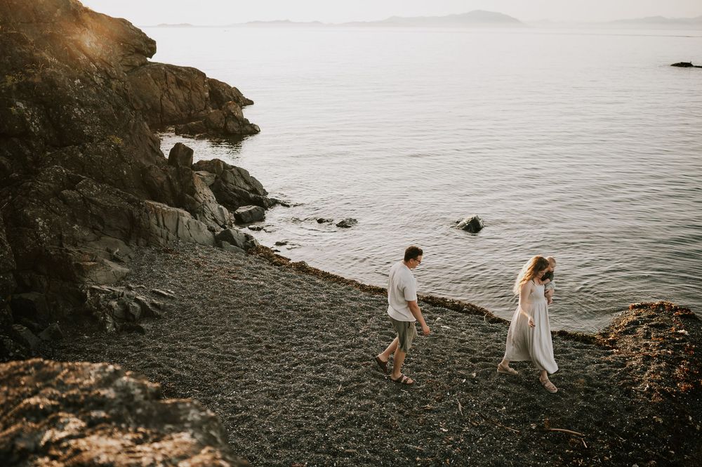Candid photo of family looking for rocks on ocean shore Neck Point Park Nanaimo sunset family photography by Vancouver Island photographer