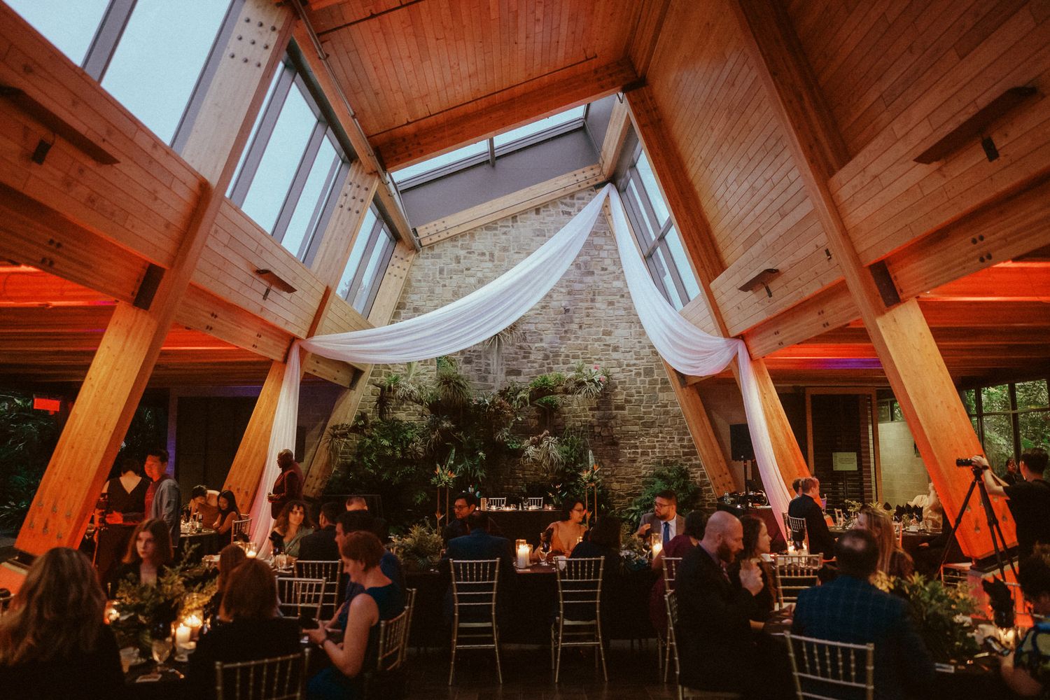 Guests dining and dancing at a joyful Calgary Zoo wedding reception, captured by a Calgary wedding photographer focused on real moments.