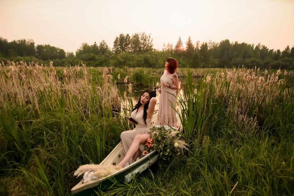 Dreamy sunset engagement photos in a tall grass field with romantic warm lighting.