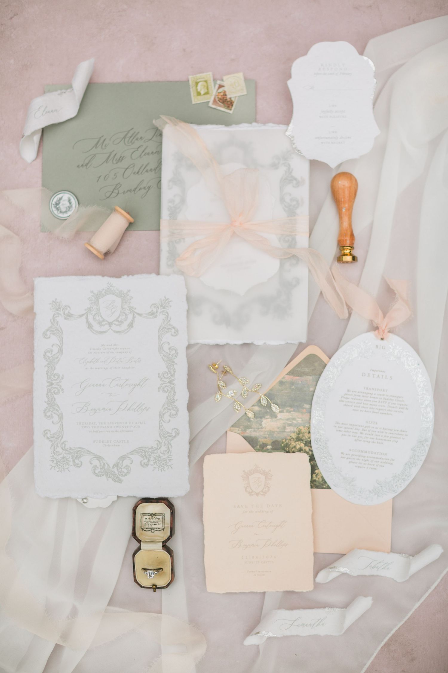 Elegant wedding flatlay featuring delicate blush and ivory stationery with vintage-inspired ornate designs and calligraphy at Sudeley Castle