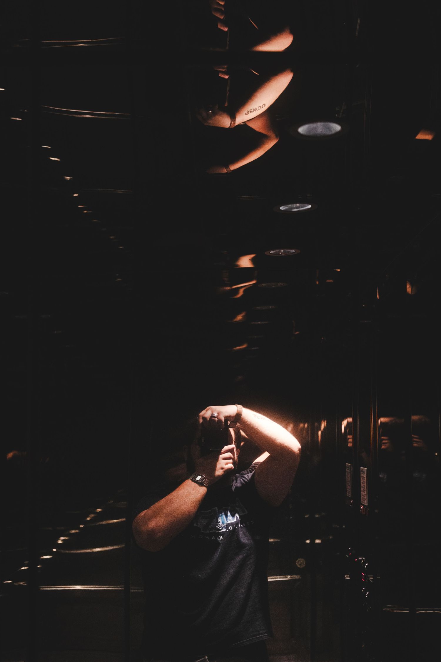Low-light concert performance with dramatic spotlight illuminating a solo performer on a dark stage.