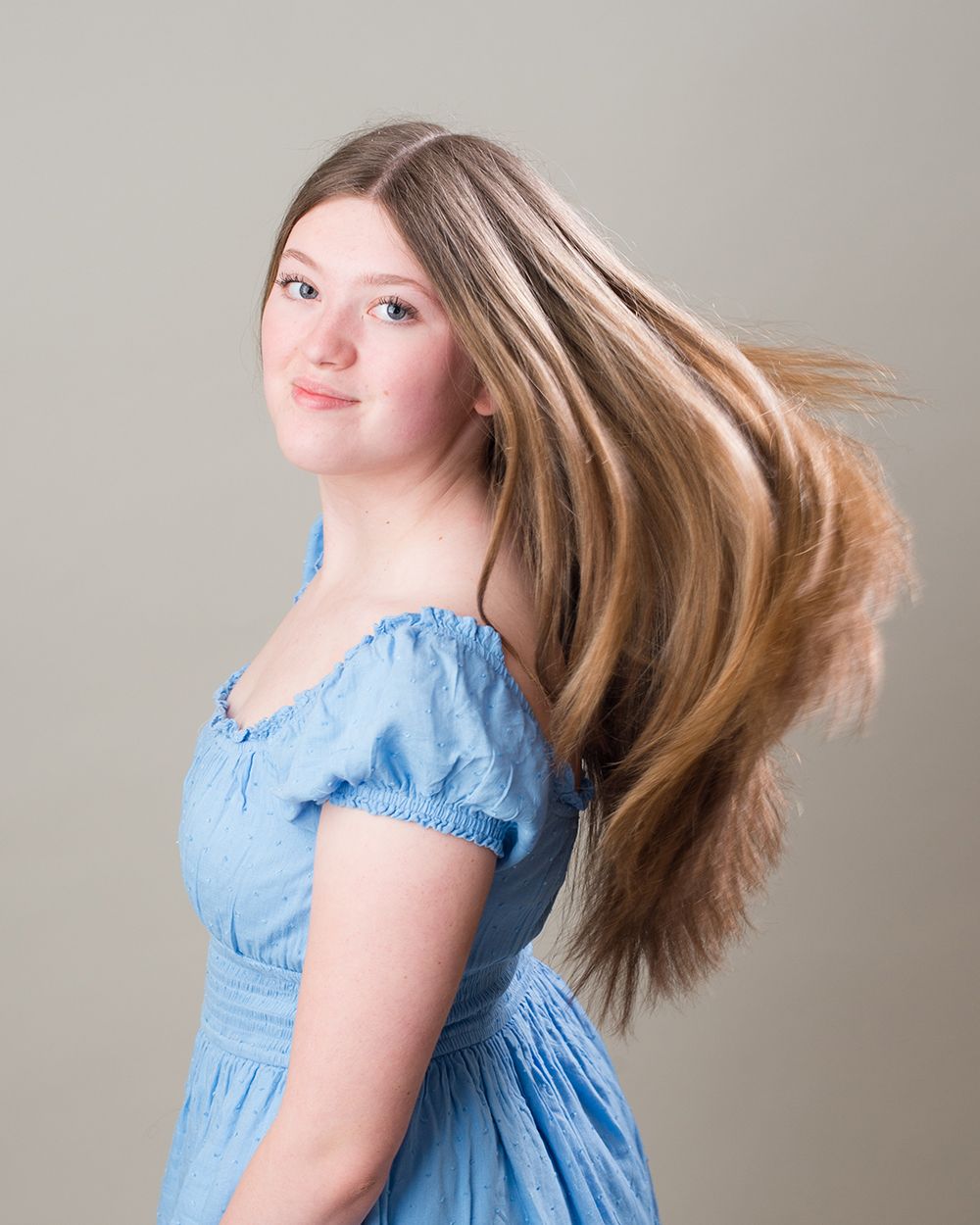 Confident girl performer in front of a spotlight-inspired backdrop — professional headshot by Abigail’s Studio, Bucks