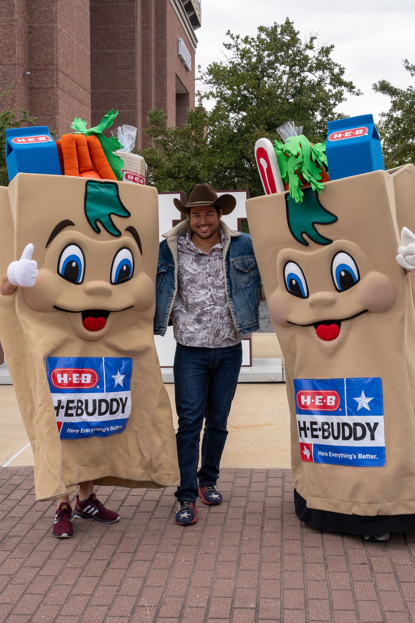 A man with two mascots