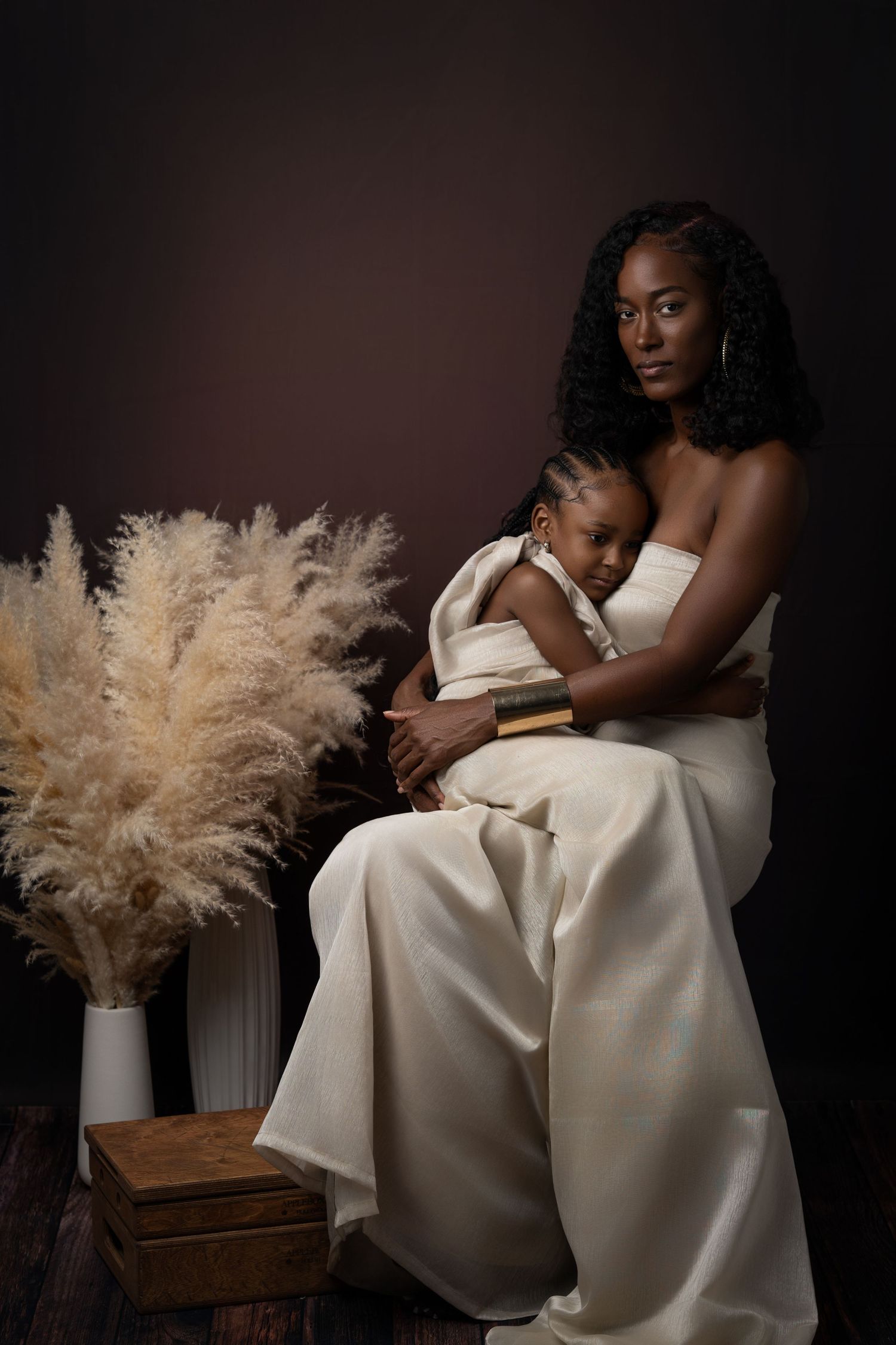 Elegant artistic series of black and white photographs showing figures in white dresses with pampas grass decor.