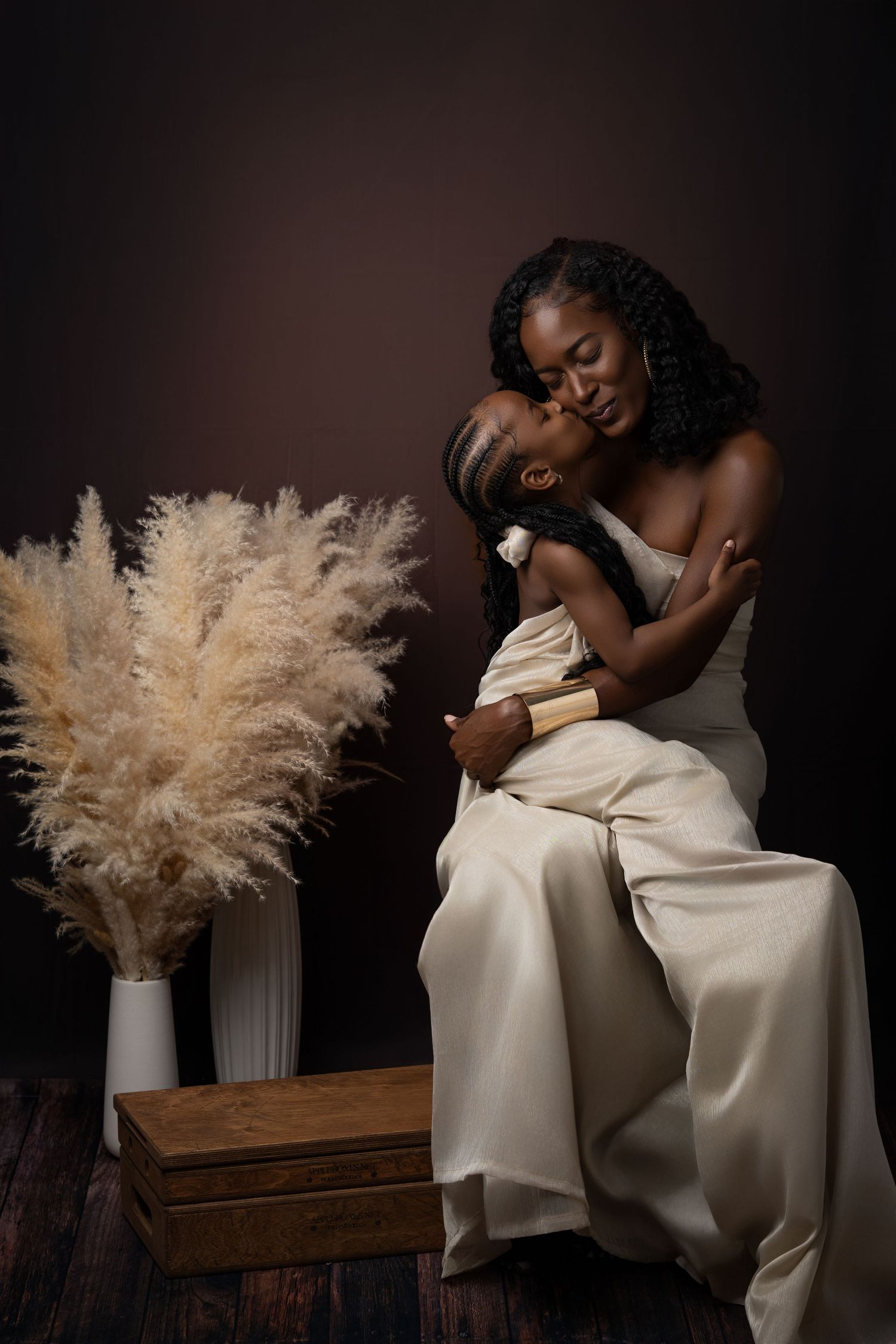 Artistic portrait series in black and white featuring someone in flowing white dress posed with dried pampas grass.