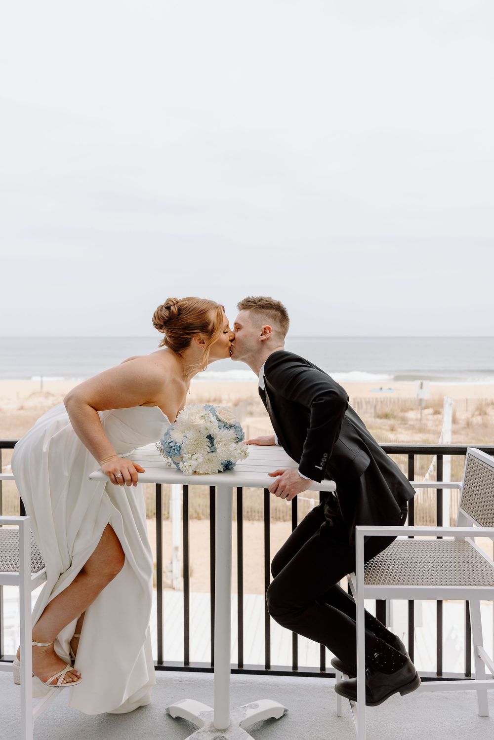 Three sequential photos of a couple having a tender moment together on a beach boardwalk with ocean views.