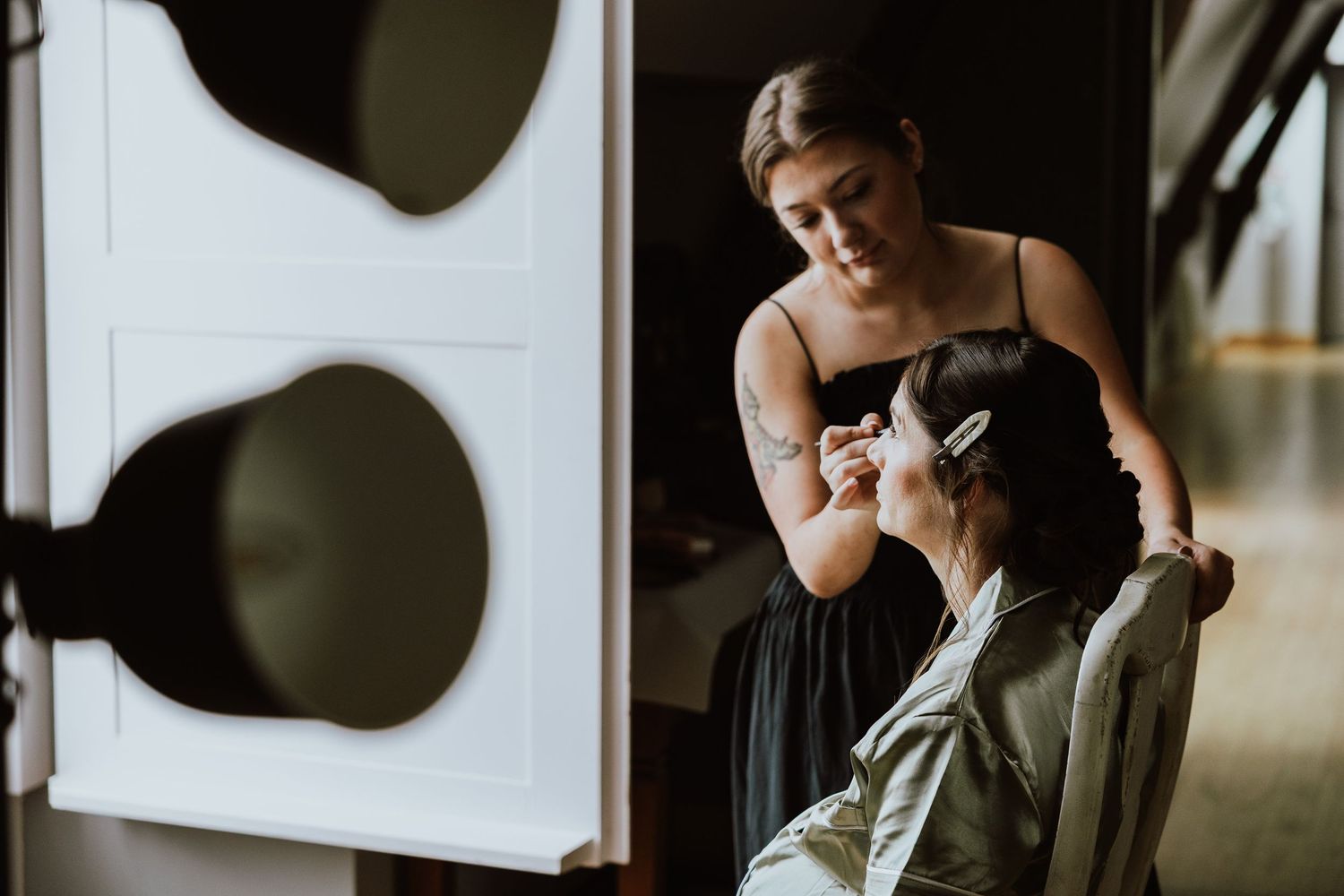 A romantic black and white photo session featuring a couple in intimate poses on a rustic wooden floor.