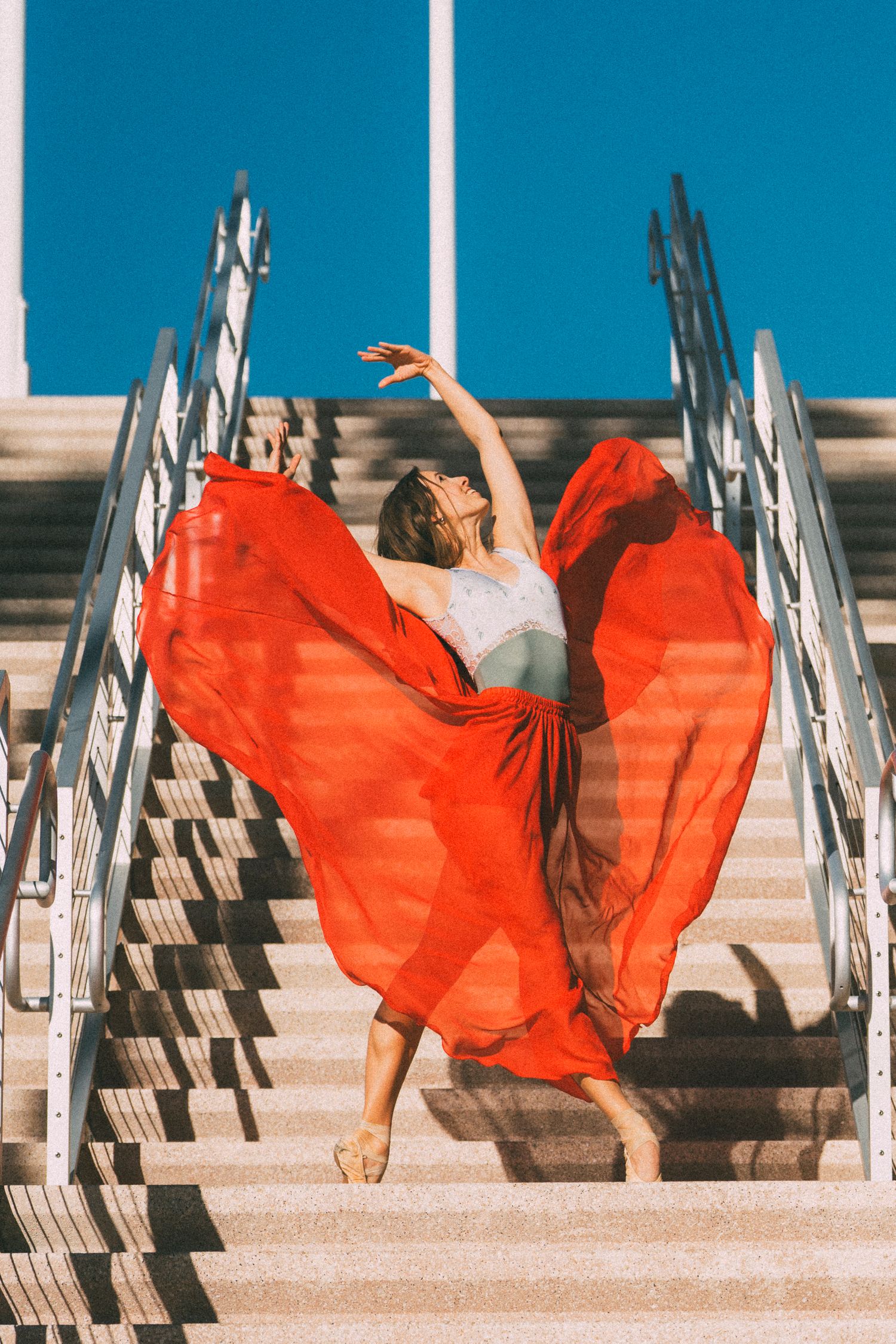 Tampa ballet dance photography of a ballerina in red skirt photographed on stairs in downtown Tampa Florida