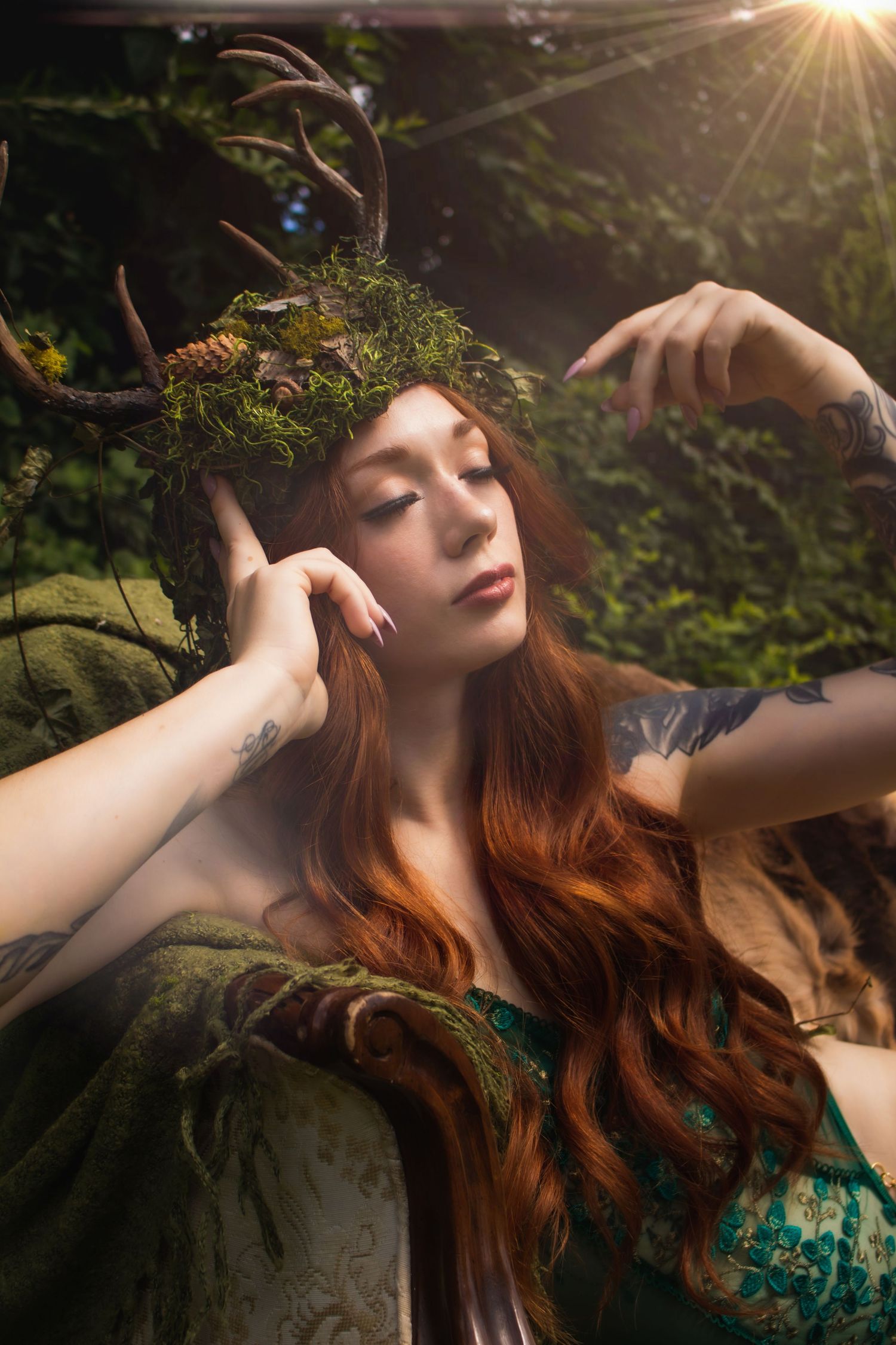 Ethereal fantasy portrait with moss crown and flowing red hair in sunlit forest setting.