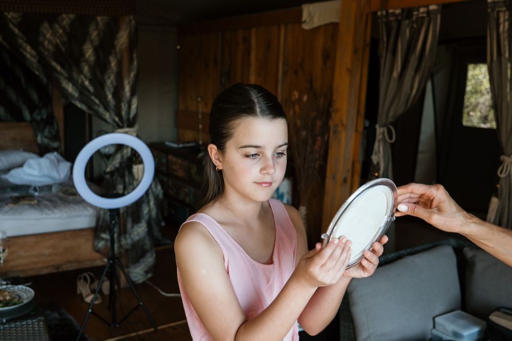Someone looks at a white object being held up in a cozy rustic interior setting.