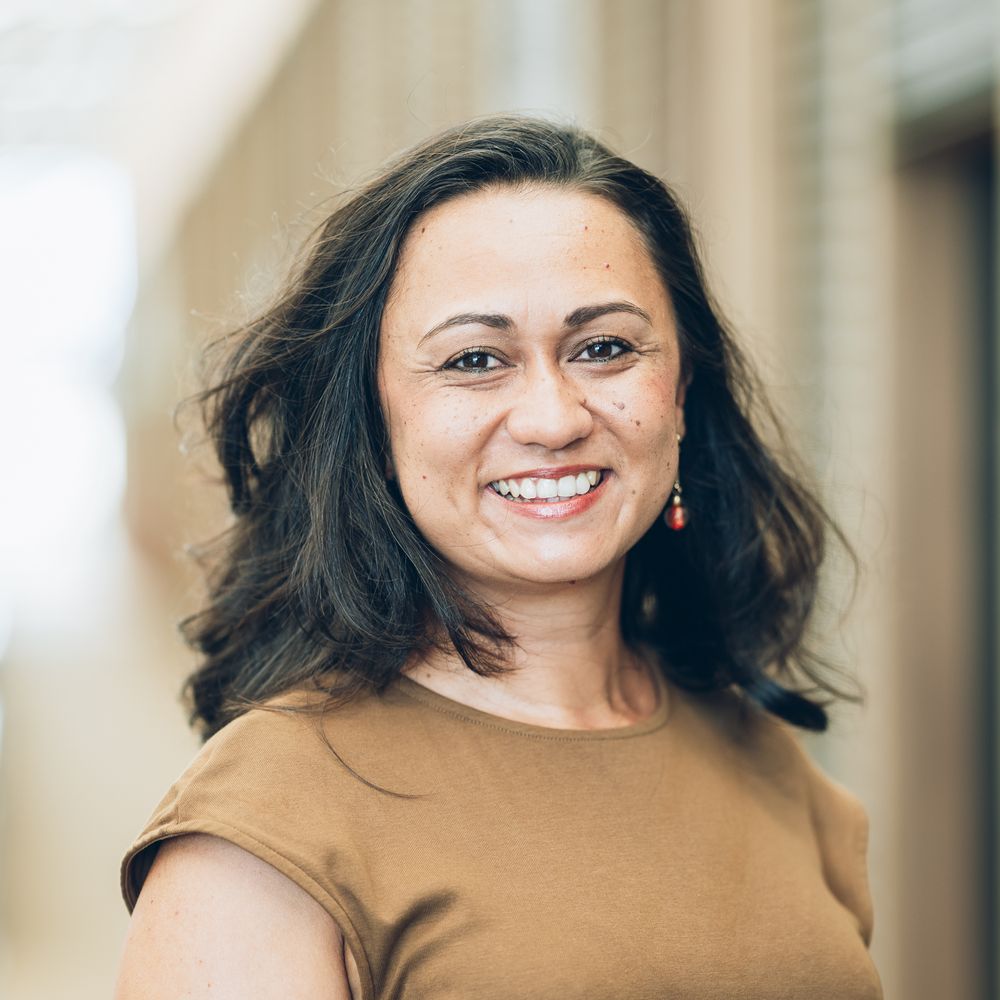 A smiling person in a brown sweater shown in a series of casual portrait photos with varying expressions.