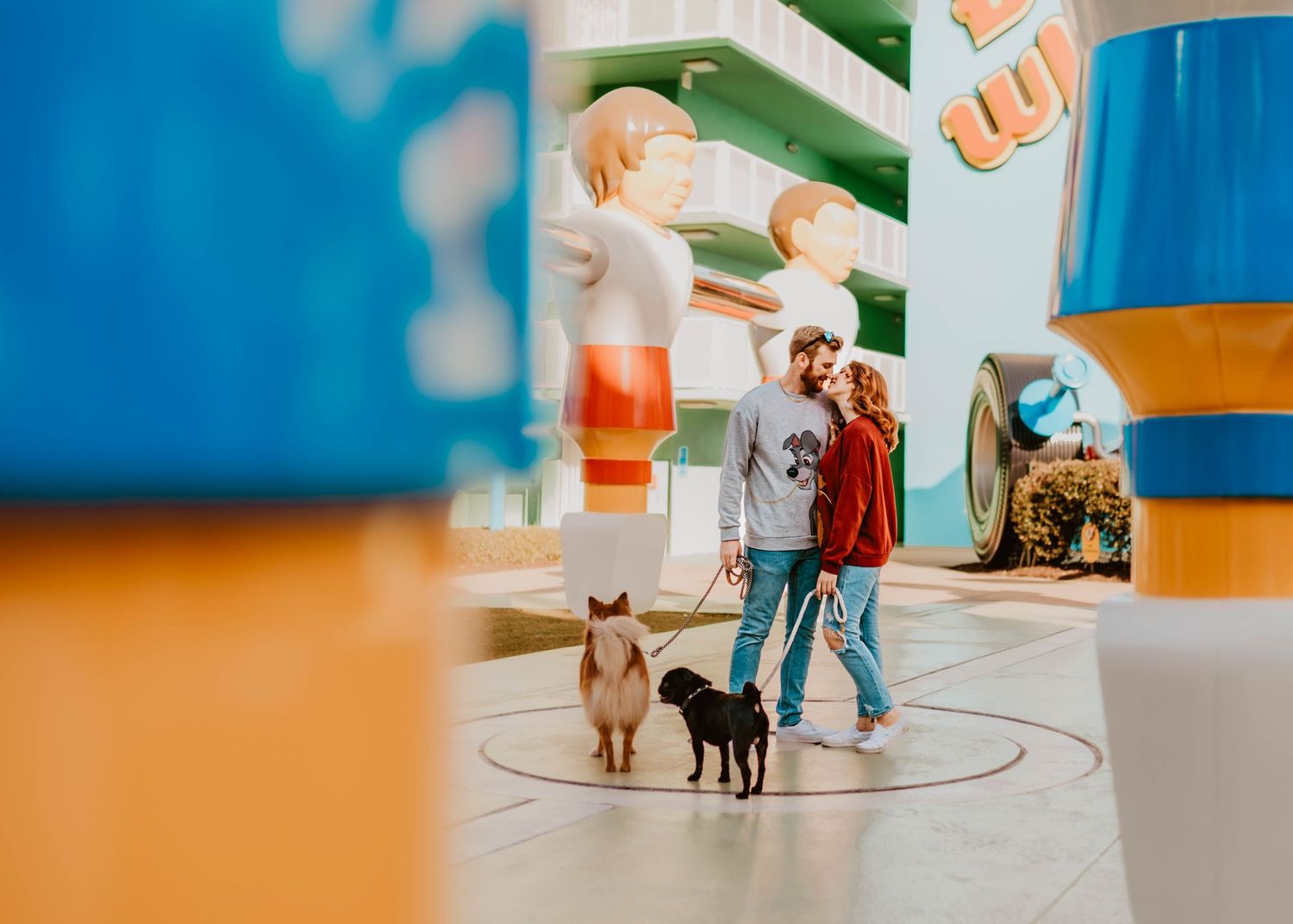 John & Emily anniversary photos at Disney's Pop Century Hotel giant foosball & their dogs. Cred: LexTakePix
