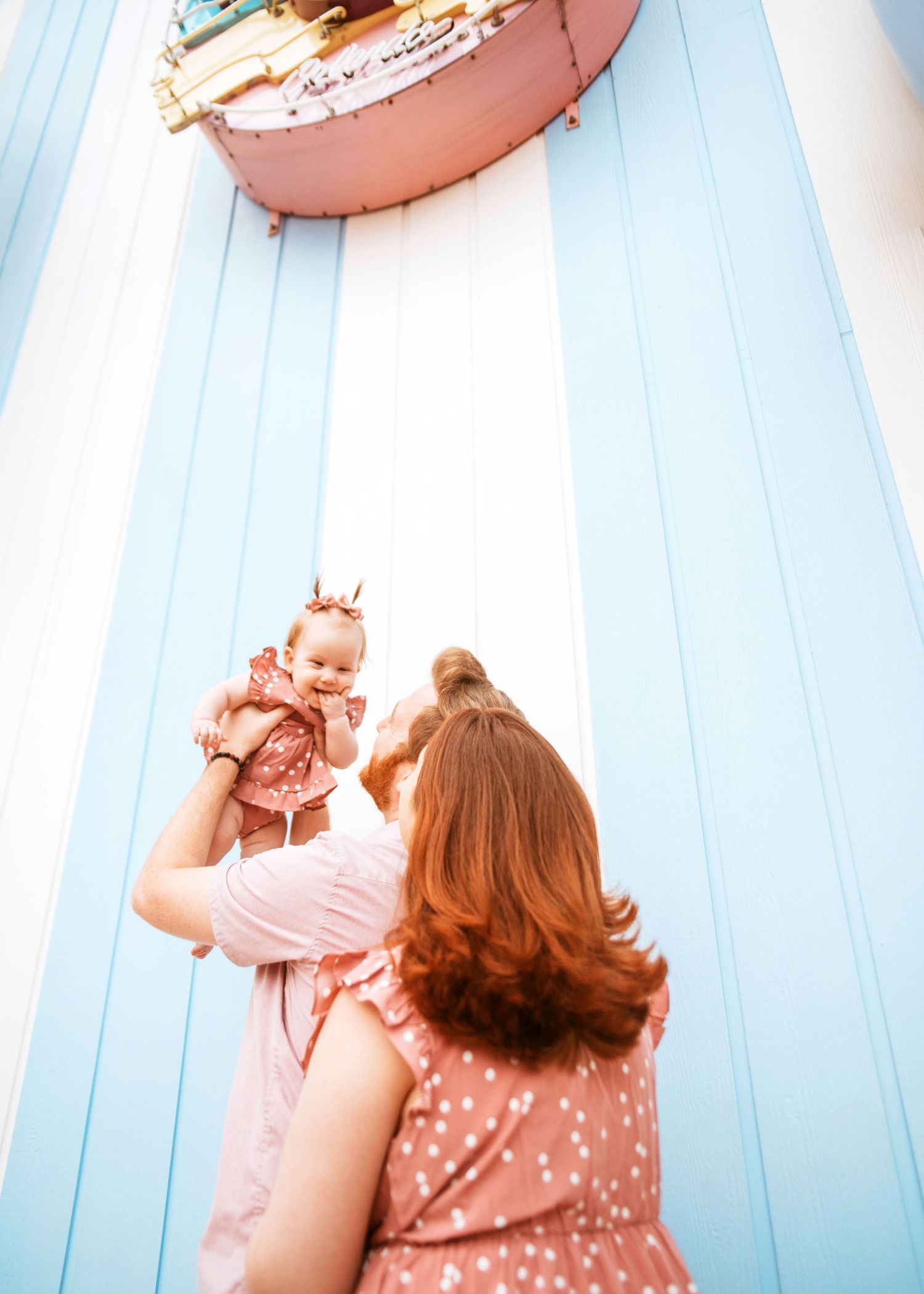 John & Emily anniversary photos at Disney Boardwalk with baby Ripley, in front of Jelly Rolls. Cred: LexTakePix